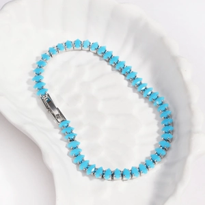 Detail of sky blue marquise zircon tennis bracelet set in silver metal on shell tray