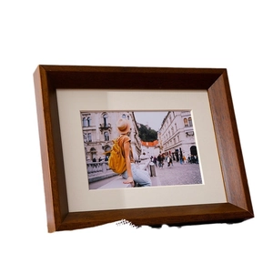 Solid walnut wood picture frame with white mat for tabletop photo display in Nordic style