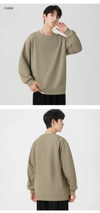 Detail of olive green crewneck sweatshirt showing ribbed cuffs and drop shoulder fit