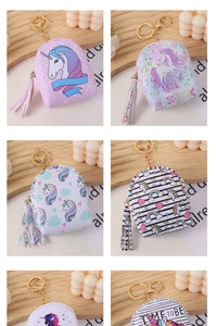 Detail of mini unicorn coin purses with golden zippers, tassels and various cute patterns