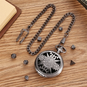 Vintage hollow gear pocket watch with chain and DND dice set on a wooden desk