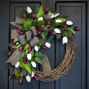 Spring tulip wreath with purple and white flowers and a plaid bow on a blue door