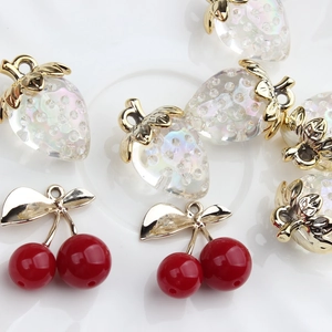 Macro shot of translucent strawberry and cherry charms on a white ceramic tray