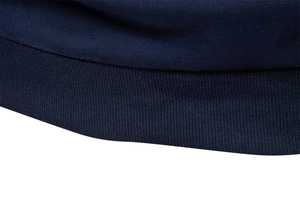 Detailed macro view of the dark blue ribbed knit hem and stitching on a men's sweatshirt