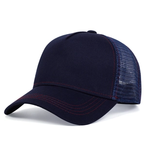 Detail view of navy trucker hat with breathable mesh and contrasting red stitching