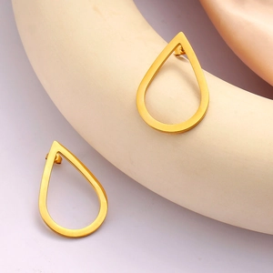 Minimalist hollow water drop gold earrings displayed on elegant silk background