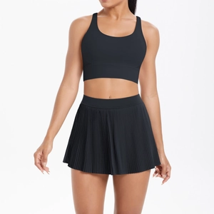 Close-up of black pleated tennis skirt and slim fit tank top with high-stretch fabric
