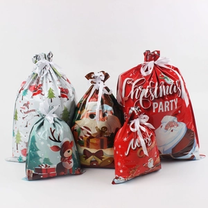 Detail of Christmas drawstring gift bags with Santa and reindeer prints in multiple sizes