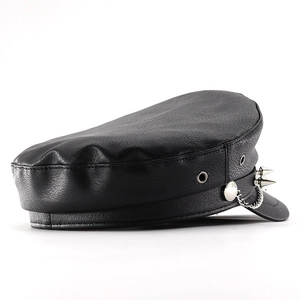 Detail view of black PU leather baker boy hat with silver chains and punk metal studs