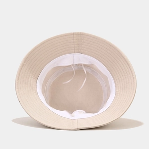 Adjustable beige hummingbird bucket hat featuring premium cotton texture and inner sweatband