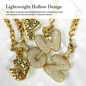 Detailed view of hollow gold-plated initial charms with brilliant pavé zircon stones