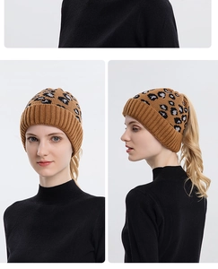 Detail of leopard print knit beanie featuring a functional ponytail hole opening