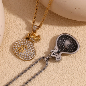 Detail of gold and silver money bag pendants with clear rhinestones and twist chains
