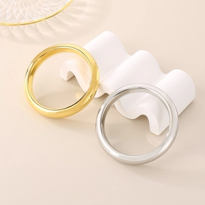 Polished 13mm wide stainless steel hollow bangle in gold and silver finish