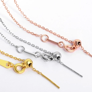 Detail of adjustable jewelry chains in gold, silver, and rose gold with slide beads