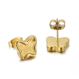 Macro detail of golden butterfly earrings with dual polished and frosted metal finishes