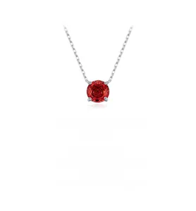 Macro view of pomegranate red faceted gemstone pendant with silver four-claw setting