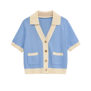 Short-sleeved light blue knit cardigan with cream contrast trim and gold crest buttons