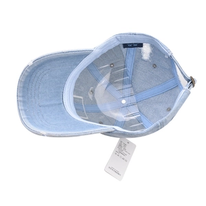 Internal view of light blue washed denim baseball cap with vintage distressed details