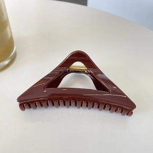 Minimalist deep red-brown 12cm triangular hair claw clip with glossy finish and metal spring