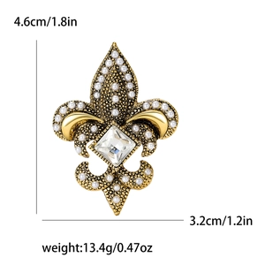 Golden fleur-de-lis brooch with pearls and rhinestones on a clean white background