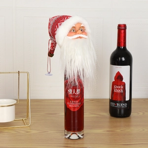 Detail of Santa Claus wine bottle cover with knitted hat and plush white beard decor