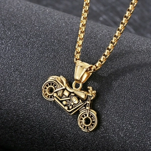 Close-up of golden stainless steel motorcycle pendant with a polished box chain detail