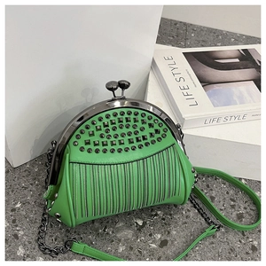 Green rivet frame bag with chain strap and leather handle on a stylish marble background