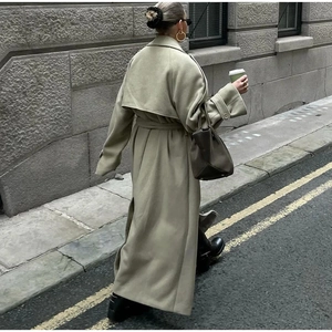 Sage green long wool coat with belted waist and oversized collar in minimalist street style