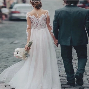 Elegant long sleeve lace wedding dress with vintage button back and tulle skirt