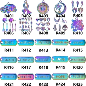 Iridescent owl and moon metal pendants with positive words engraved on a white background
