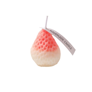 Pink and white gradient strawberry scented candle with handmade tag on white background