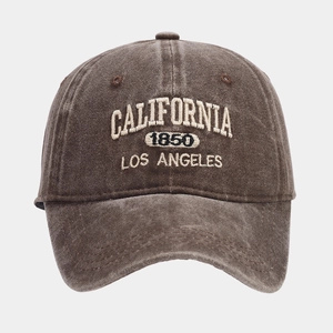 Close-up of vintage washed brown cotton baseball cap featuring ivory CALIFORNIA embroidery