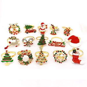 Set of 15 Christmas napkin rings featuring reindeer and tree motifs in gold metal finish