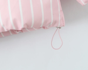Close-up of pink and white striped fabric with adjustable elastic drawstring and metal toggles