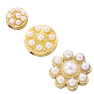 Close-up of golden sunflower bead accessories with faux pearl inlay for DIY jewelry