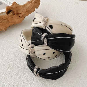Polka dot and heart patterned wide headbands with rhinestone knots in black and beige