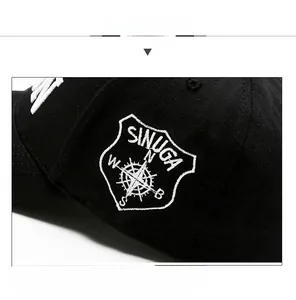 Close-up of white 3D embroidery on a black cotton baseball cap showing detailed stitching