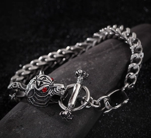 Detailed view of silver wolf head bracelet with red crystal eyes and T-bar clasp closure