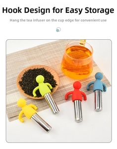 Detail of colorful human-shaped silicone and stainless steel tea infusers on a desk