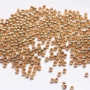 Pile of high-quality 14k gold-filled round spacer beads for DIY jewelry making accessories