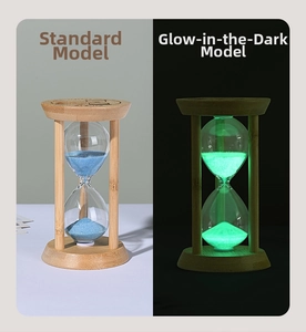 Detail of wooden hourglass timer showing regular blue sand and green luminous night style