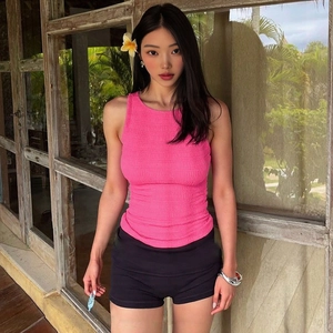 Détail du haut sans manches froncé rose avec short noir ajusté pour un style d'été chic