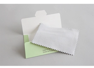 Microfiber silver polishing cloth in a light green and white envelope packaging