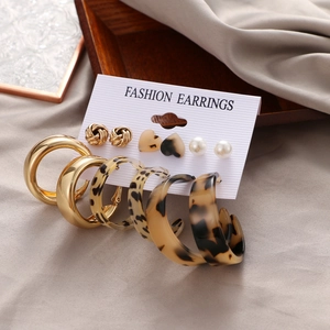 Detail view of 6-pair gold earring set with leopard print and pearls on display card