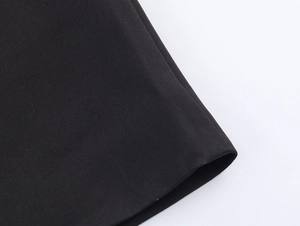Detailed macro view of black woven fabric texture and stitching on a street style coat