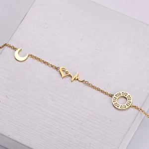 18k gold plated stainless steel bracelet featuring heart moon and meander charm pendants