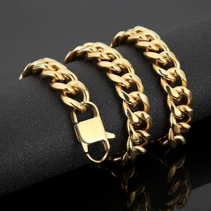 Detail of gold Cuban link chain with lobster clasp wrapped on a black jewelry display