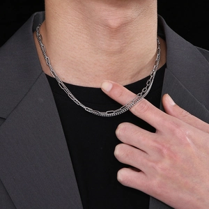 Detail view of silver layered Cuban and paperclip chain necklace with OT buckle clasp