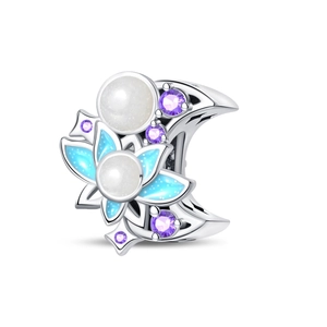 Macro detail of moon and flower bead with blue enamel and purple zircon stones